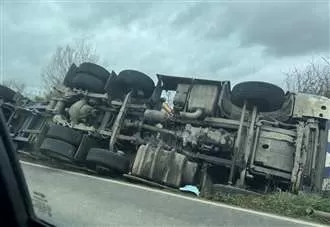 Man taken to hospital after lorry overturns on busy route