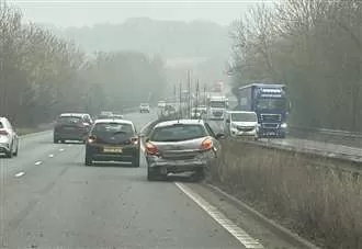 A2 partly blocked as car hits central reservation after crash