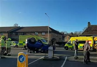 Car flips onto roof after crash on busy route