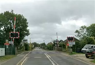 Car and train crash at level crossing triggering emergency response